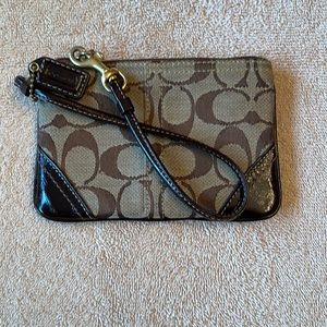 Coach wristlet Jacquard Signature C Tan with Brown Leather trim.